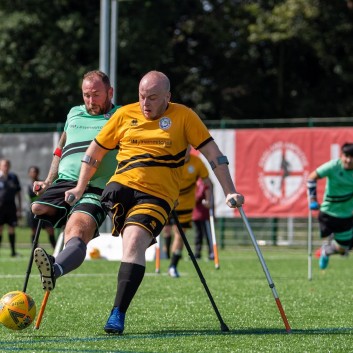 Mark Smith, amputee football player strikes the ball in a match