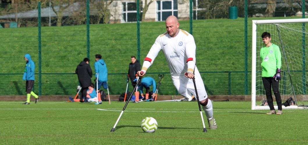 Mark Smith, amputee football player about to kick the ball in a match